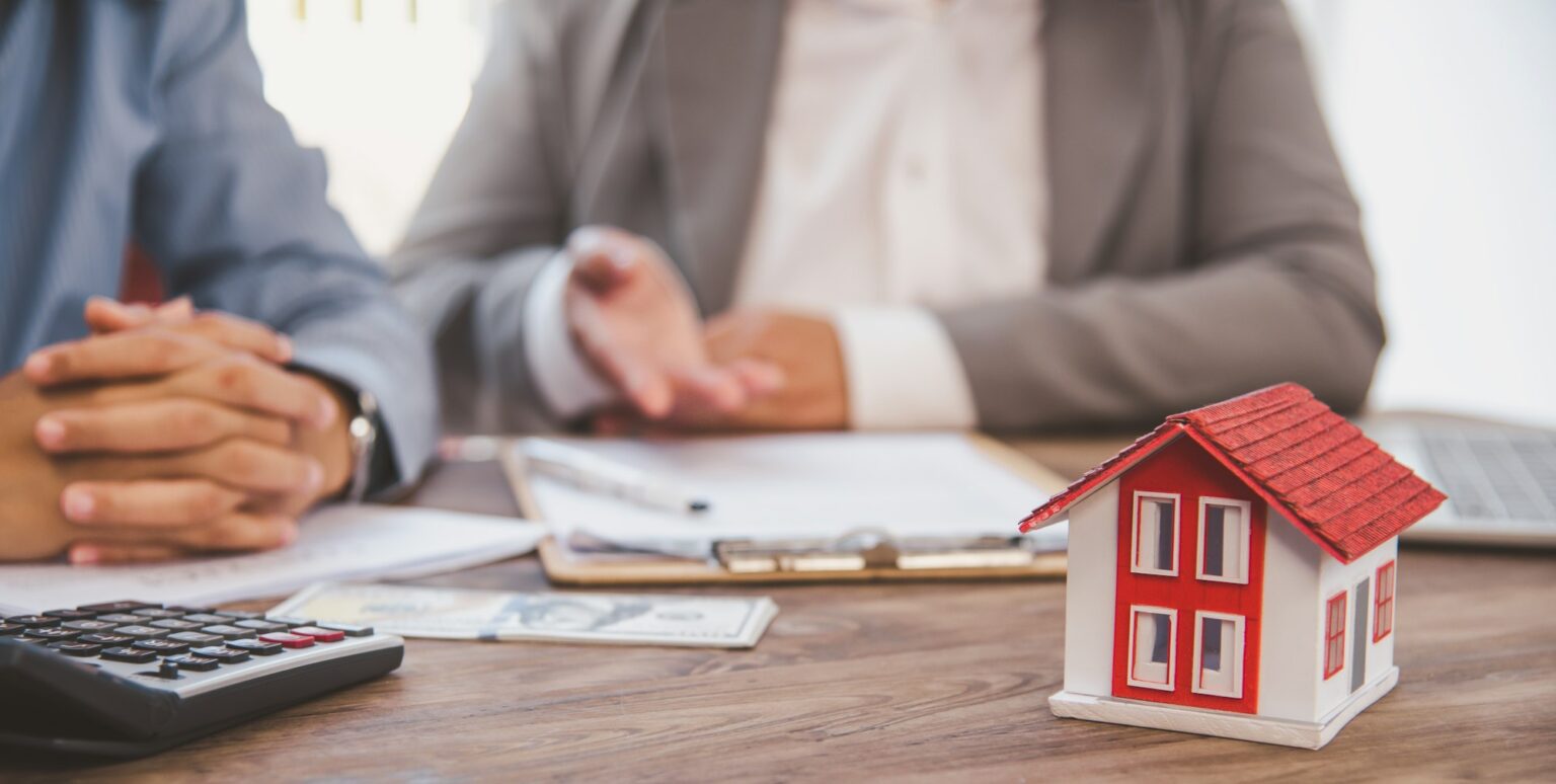 House signers signing signature loan document to home ownership with real estate agents ownership