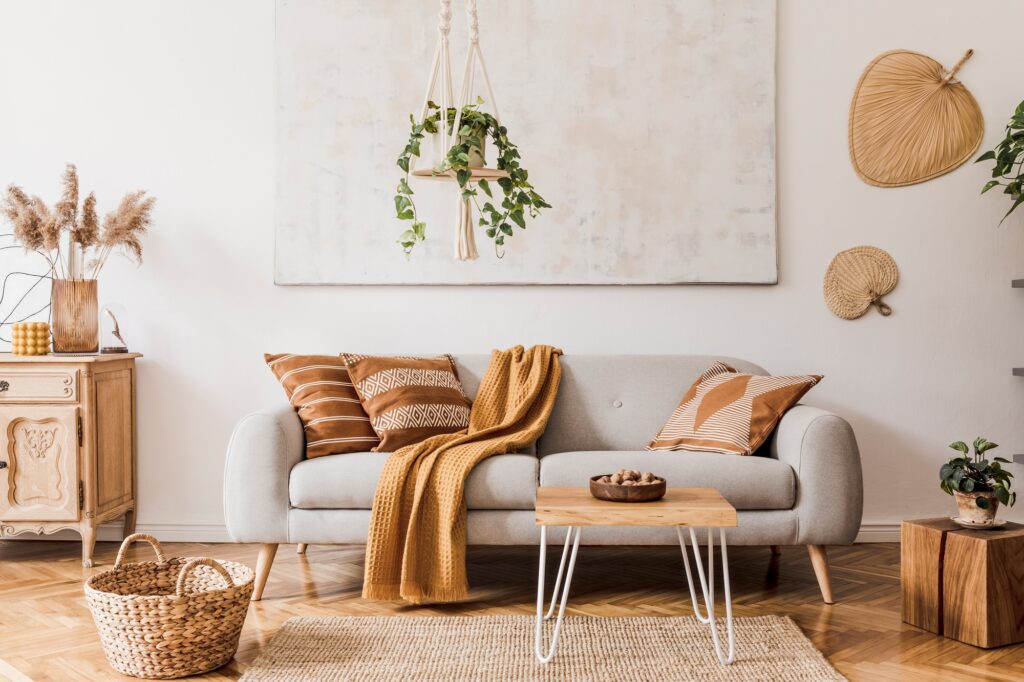 Stylish composition of creative and cozy living room interior with grey sofa.