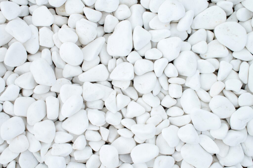 Pure texture of white pebbles. Small stones on the ground.