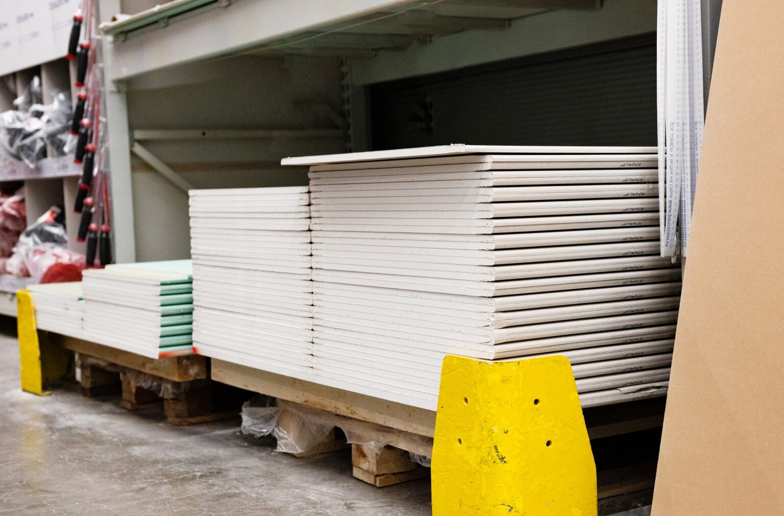 Drywall standard gypsum panels, wallboards plasterboard stacked in hardware store closeup