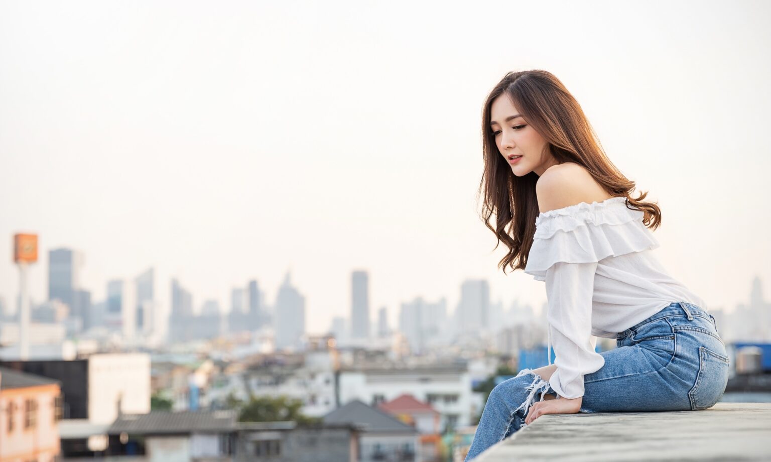 Portrait of young beautiful asian woman sitting in sky fresh air roof top